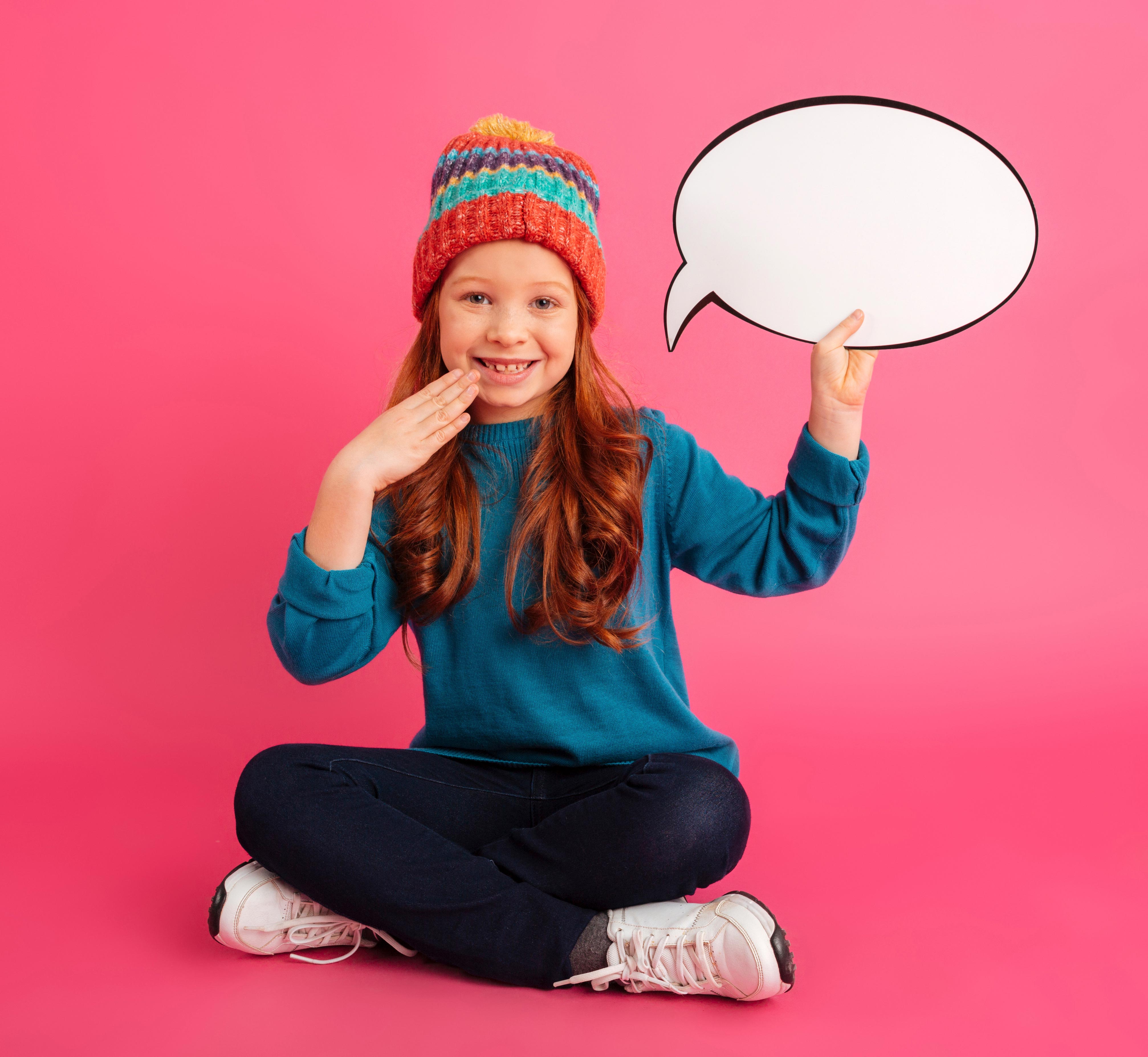 smiling-girl-looking-camera-holding-bubble-speech-s