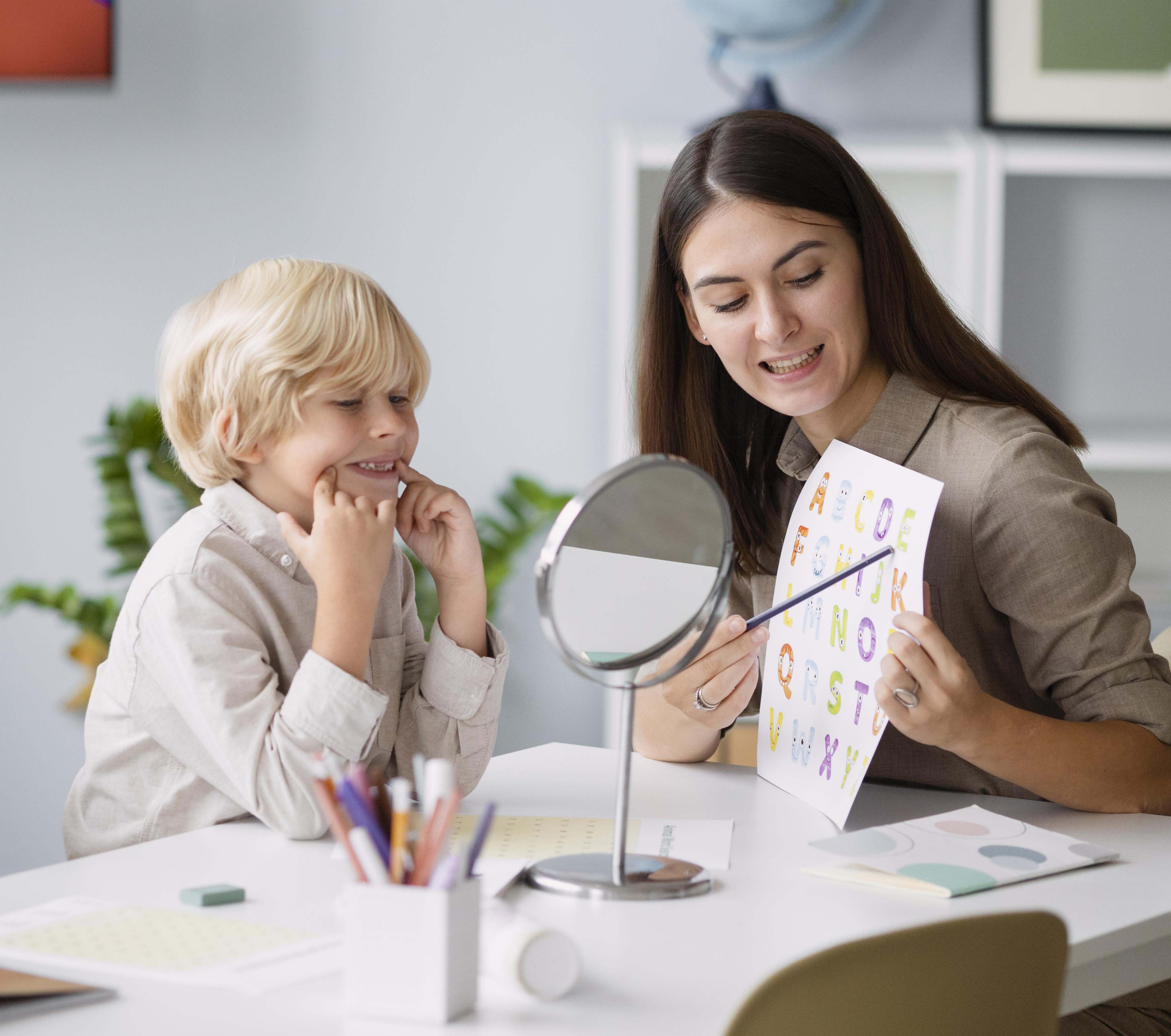 woman-doing-speech-therapy-with-little-boy-her-clinic woman-doing-speech-therapy-with-little-boy-her-clinic