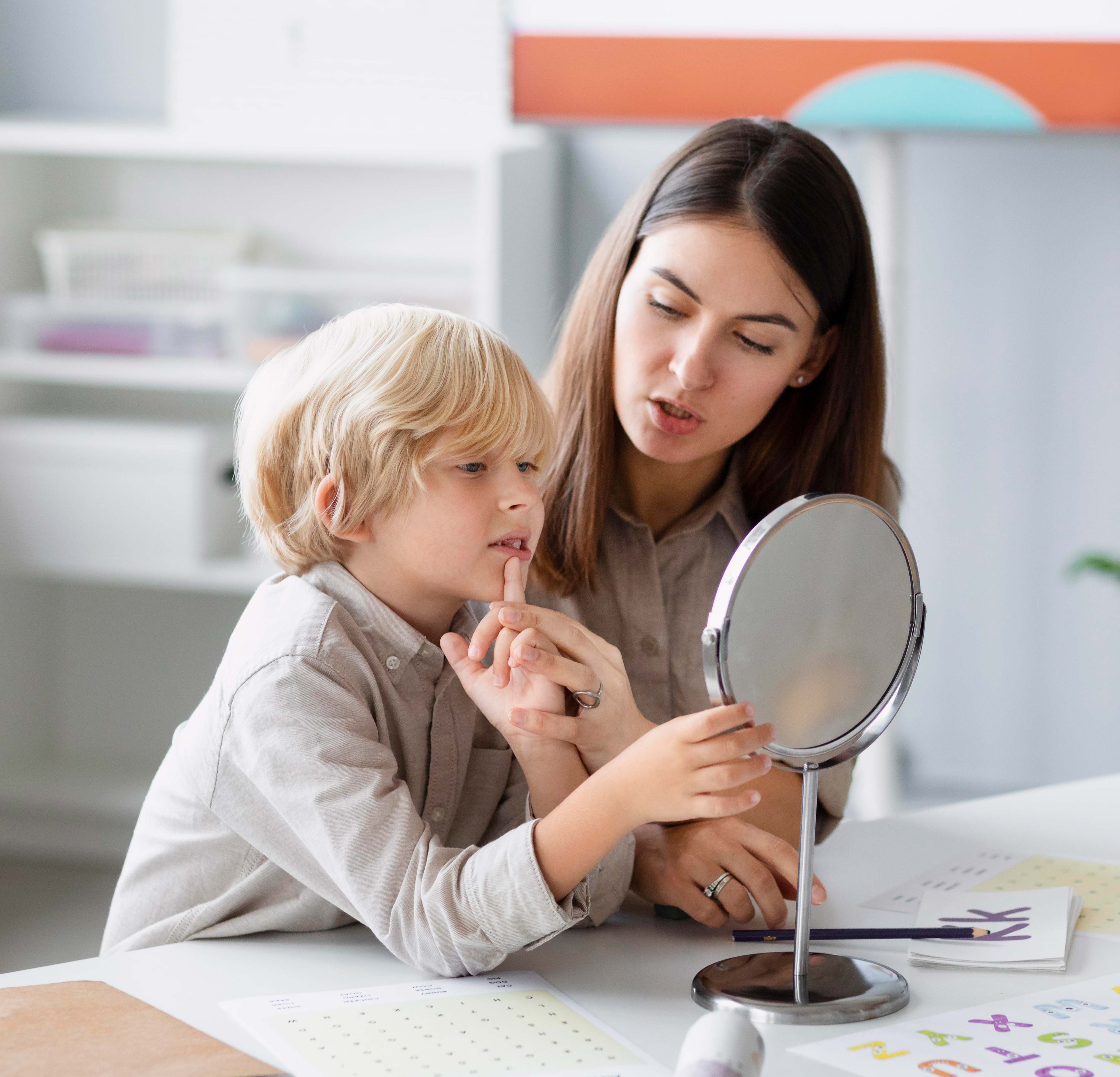 woman-doing-speech-therapy-with-little-boy-her-clinic-s
